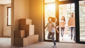 Family walking into new home with moving boxes